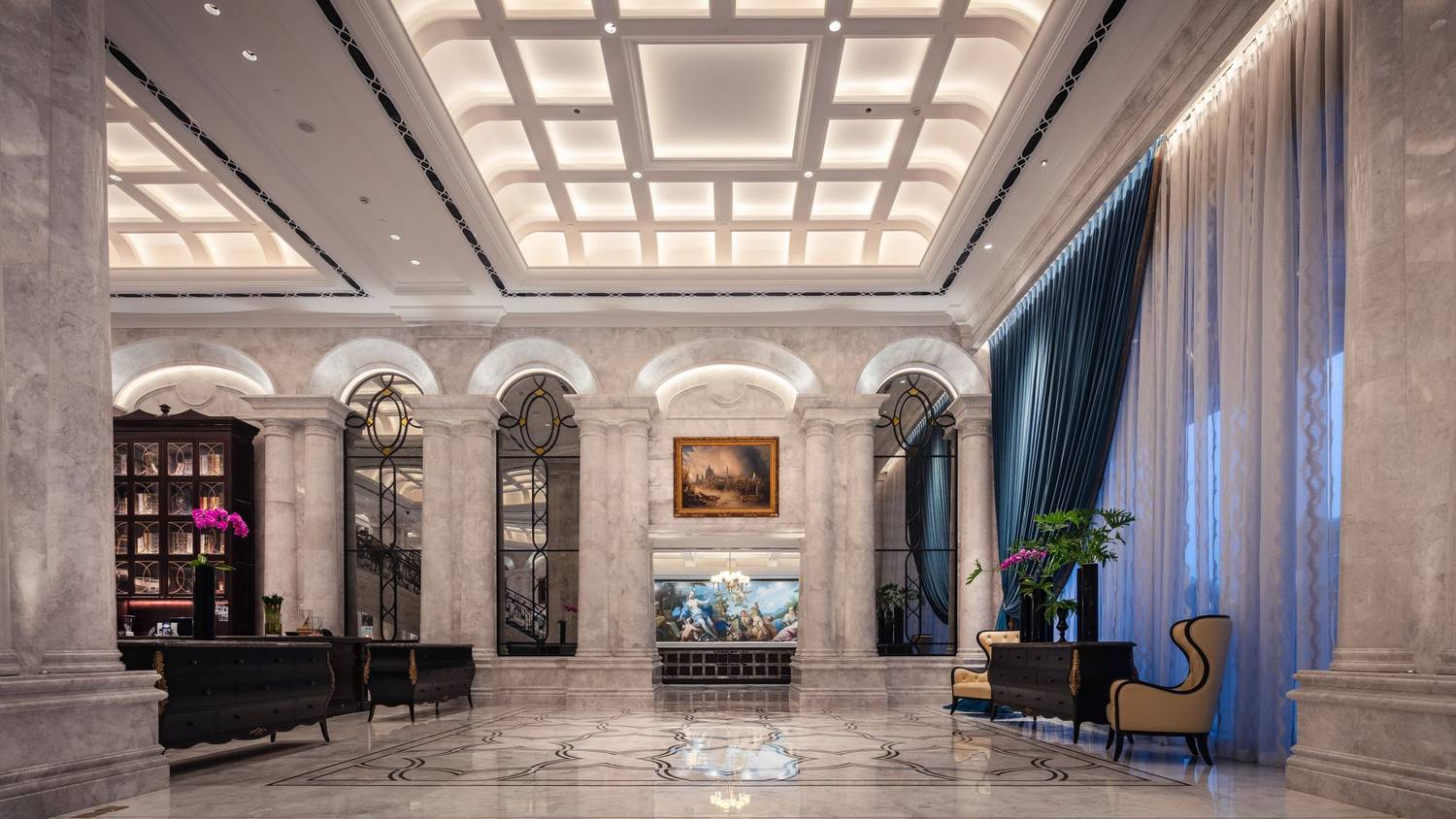 Elegant hotel lobby interior with marble columns, luxurious decor, and vibrant lighting.