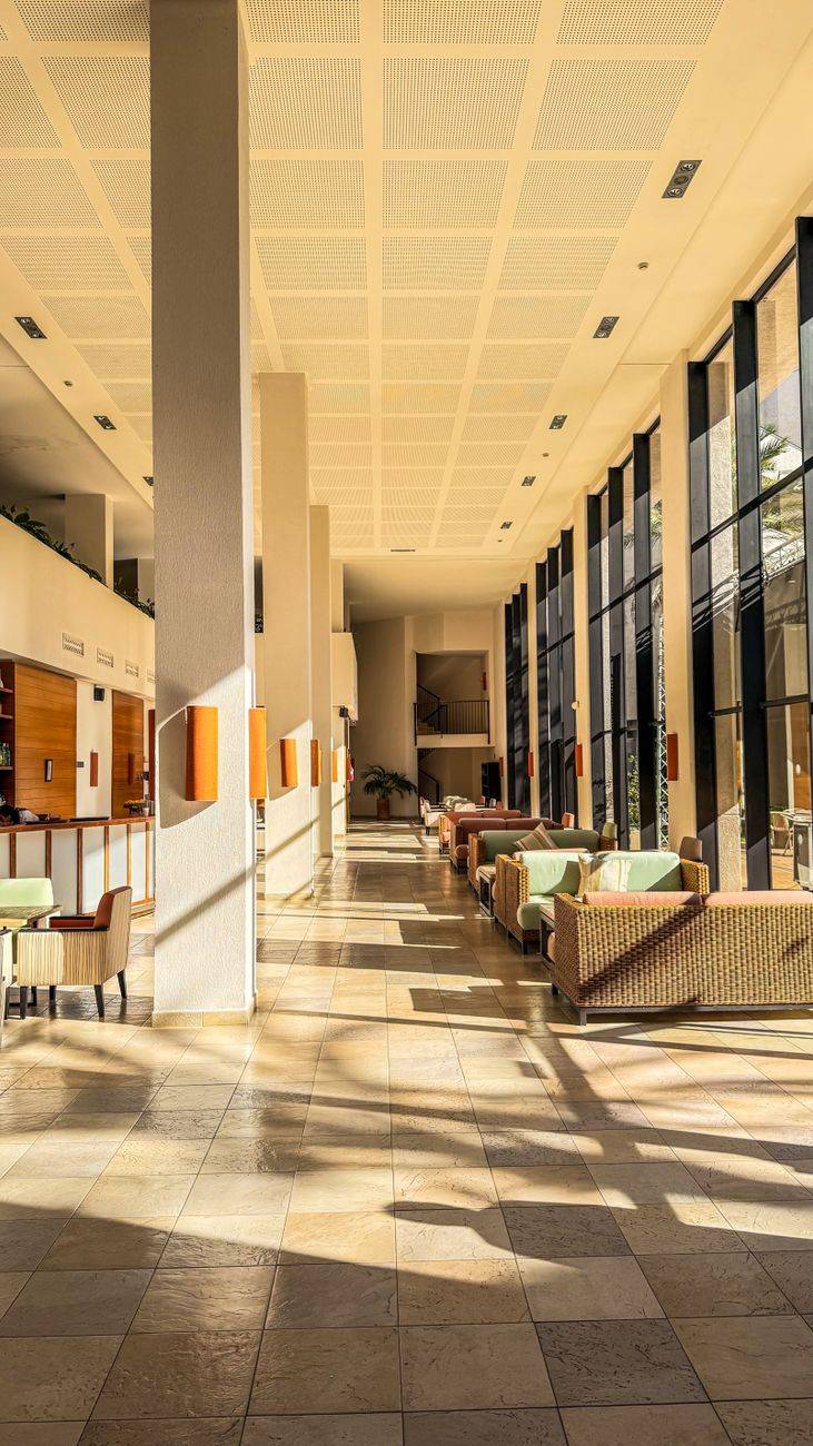 Bright and spacious hotel lobby with modern design and ample seating.