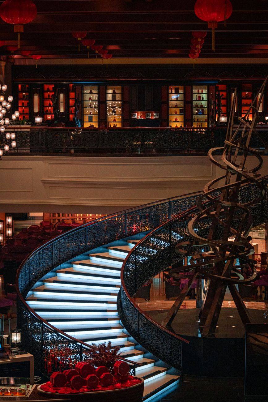 Elegant spiral staircase in a luxury hotel lobby in Pasay, Philippines.