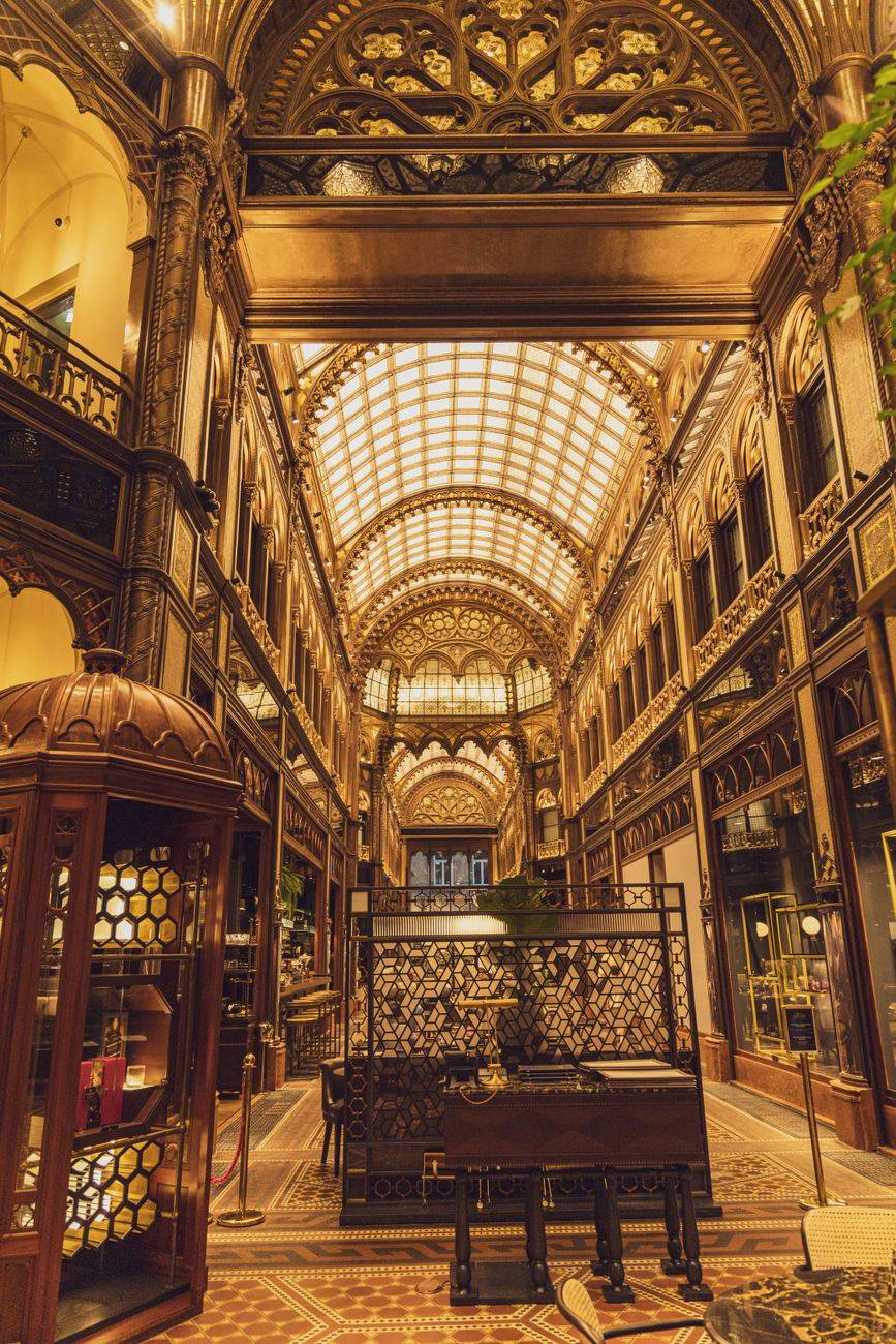 Interior of aged old fashioned hotel with arched passage decorated with ornamental elements in Budapest