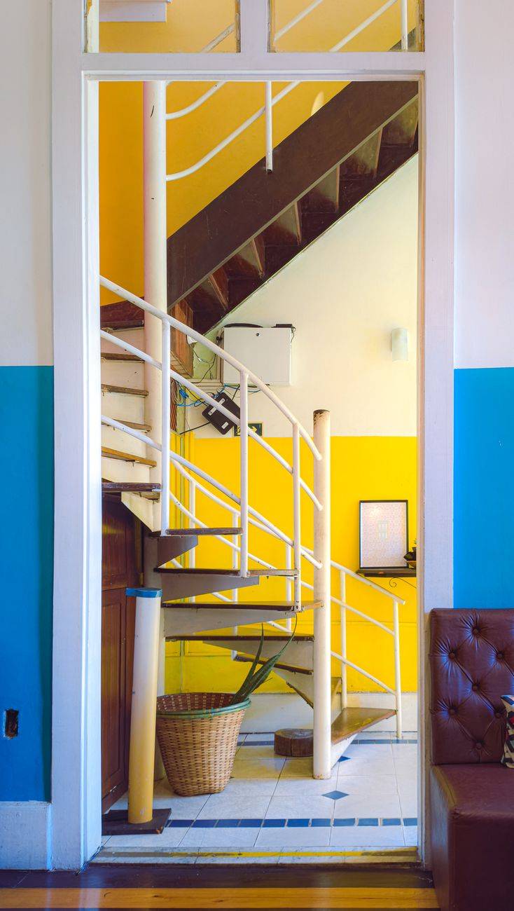 Colorful interior featuring a spiral staircase and modern design elements.