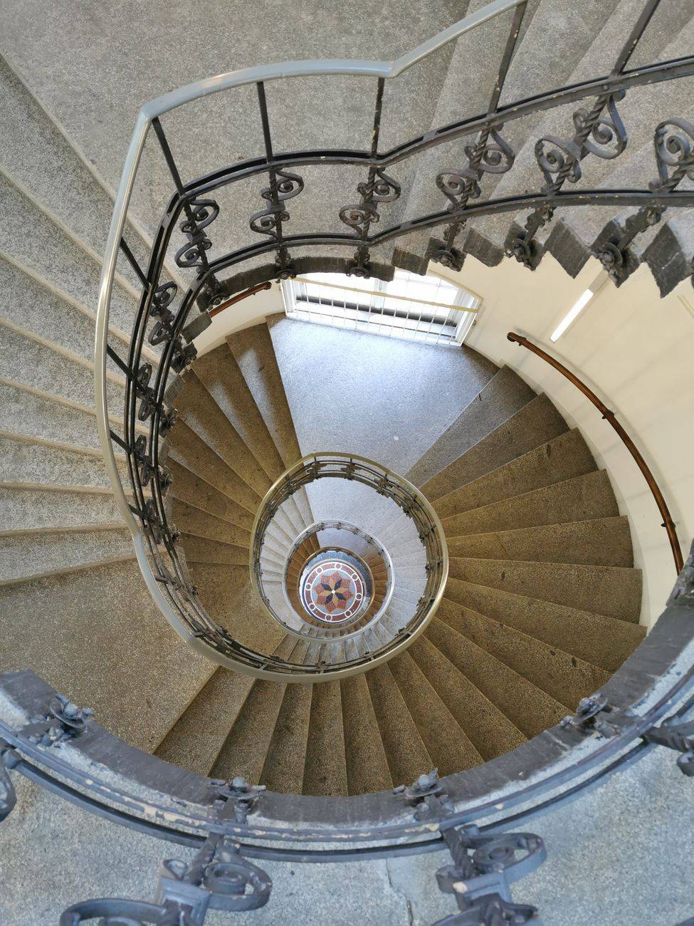 A top-down view of a spiral staircase showcasing intricate railing details.