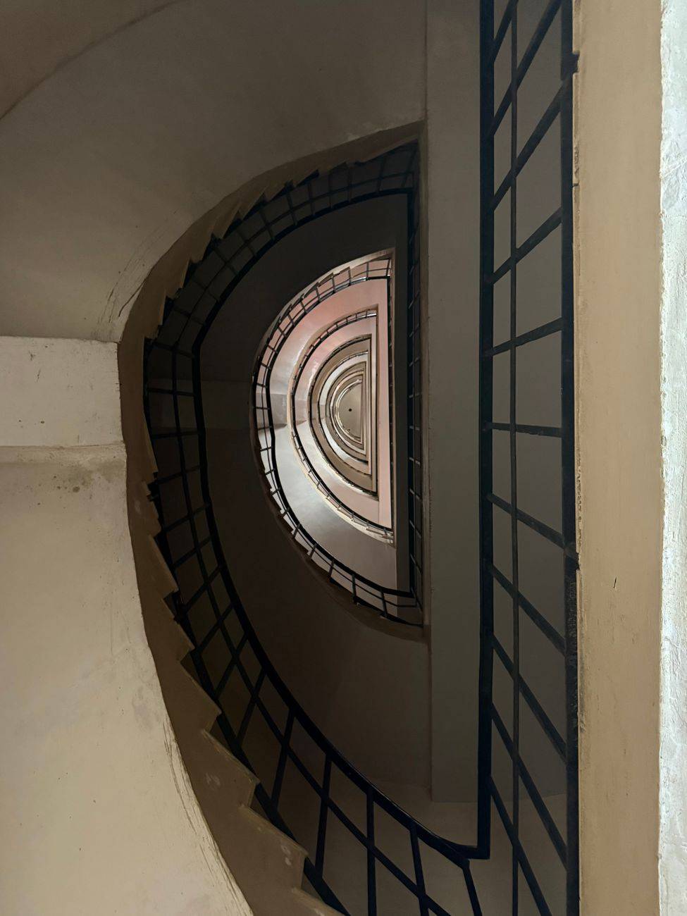 A captivating view of a spiral staircase showcasing geometric patterns and symmetry.