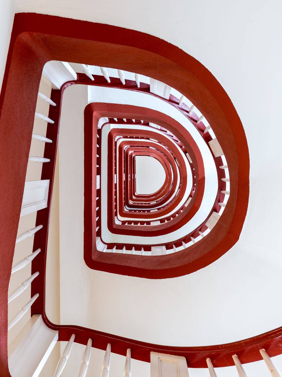 Capture the architectural beauty of a spiral staircase in a Hamburg office building.