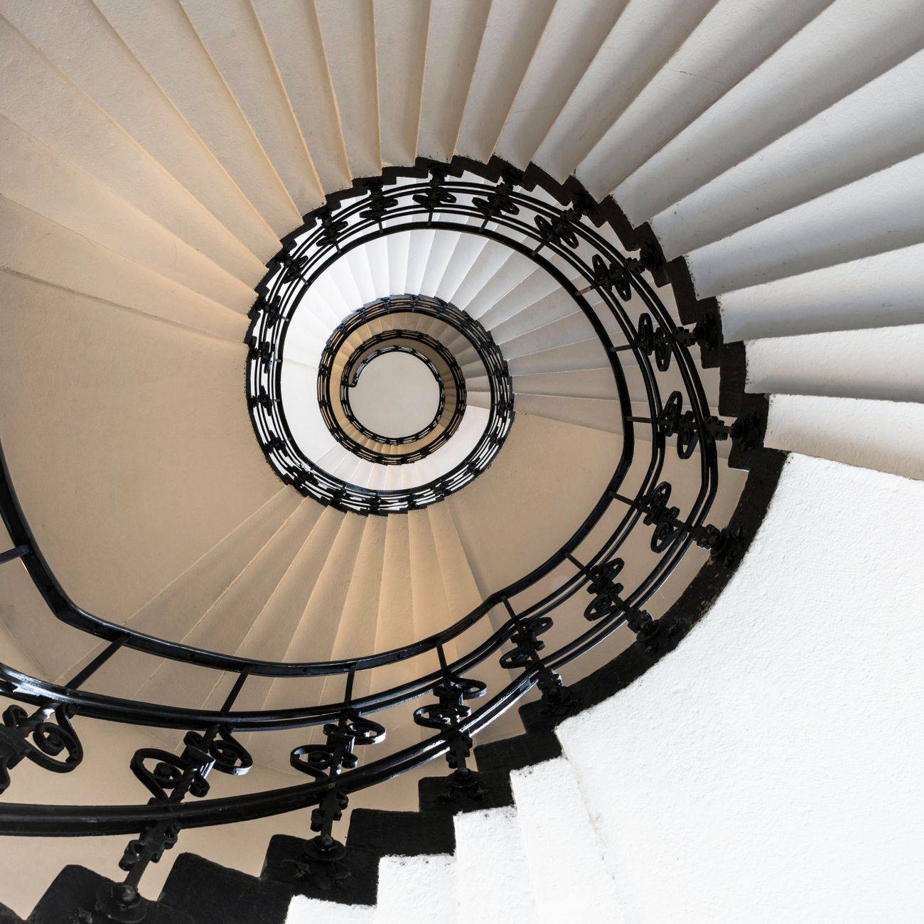 A captivating view of a classic spiral staircase with intricate railing in Hamburg, Germany.
