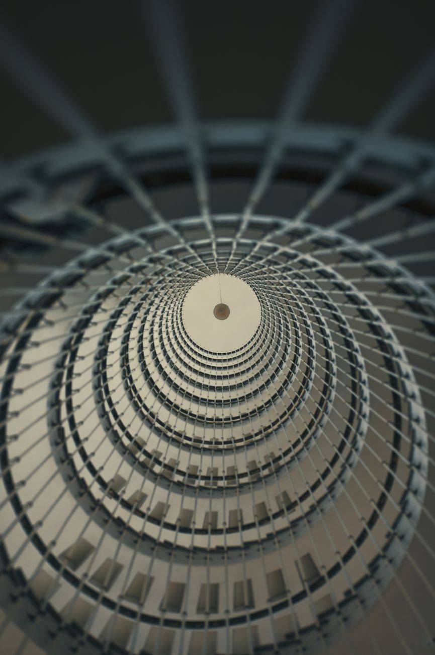 Dramatic view of a modern spiral staircase in Barakaldo, showcasing architectural elegance.
