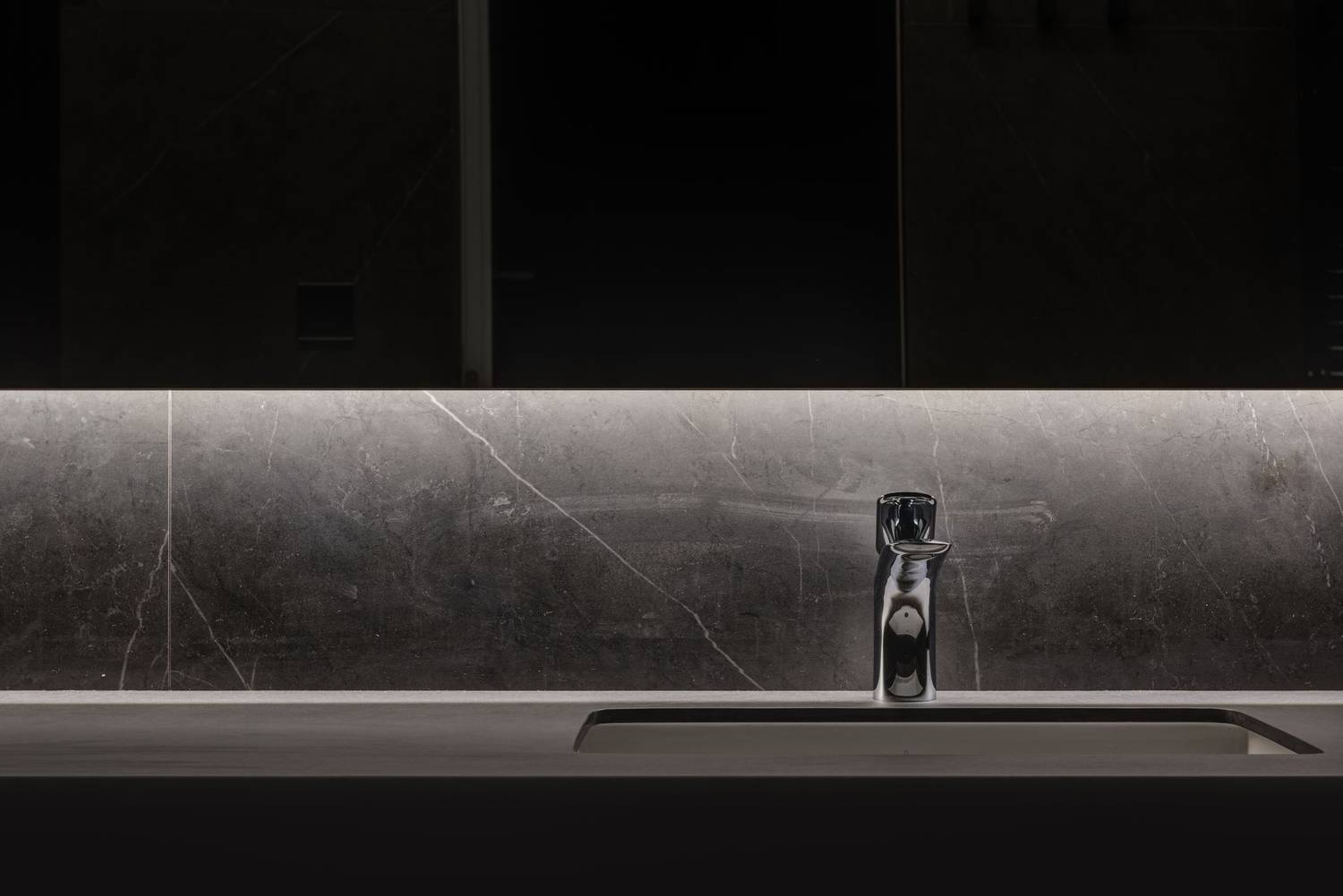 Loft design of contemporary bathroom with glass cabinet over marble part of wall and chrome faucet
