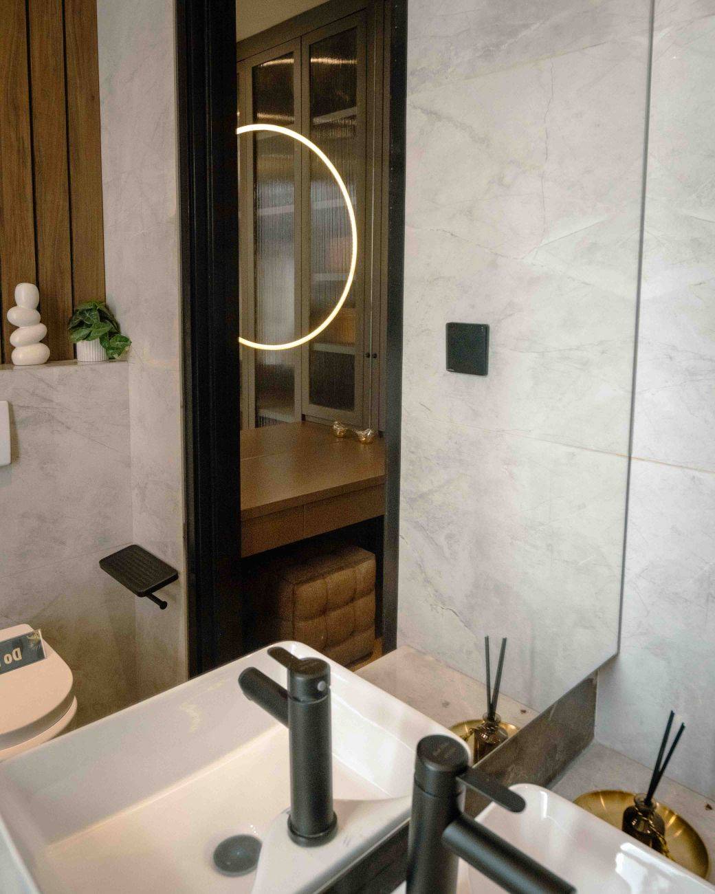 Contemporary bathroom featuring sleek fixtures and a cozy interior with unique lighting.