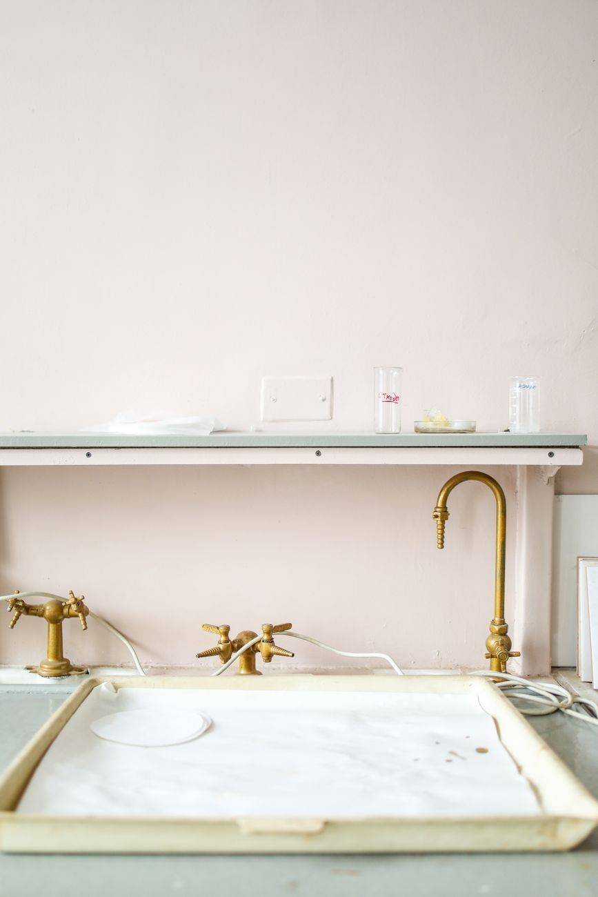 A clean laboratory setup featuring brass faucets and minimalistic design elements.
