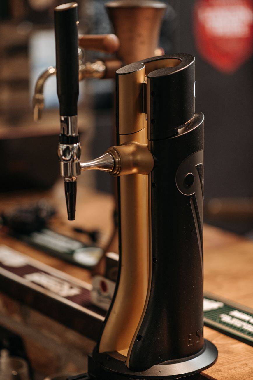 A stylish beer tap in a bar, highlighting modern design and cozy ambiance.