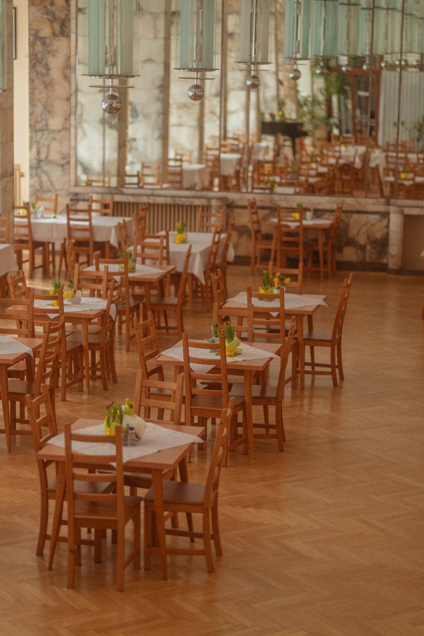 Charming restaurant interior with wooden chairs and tables in Krynica-Zdrój, Poland.
