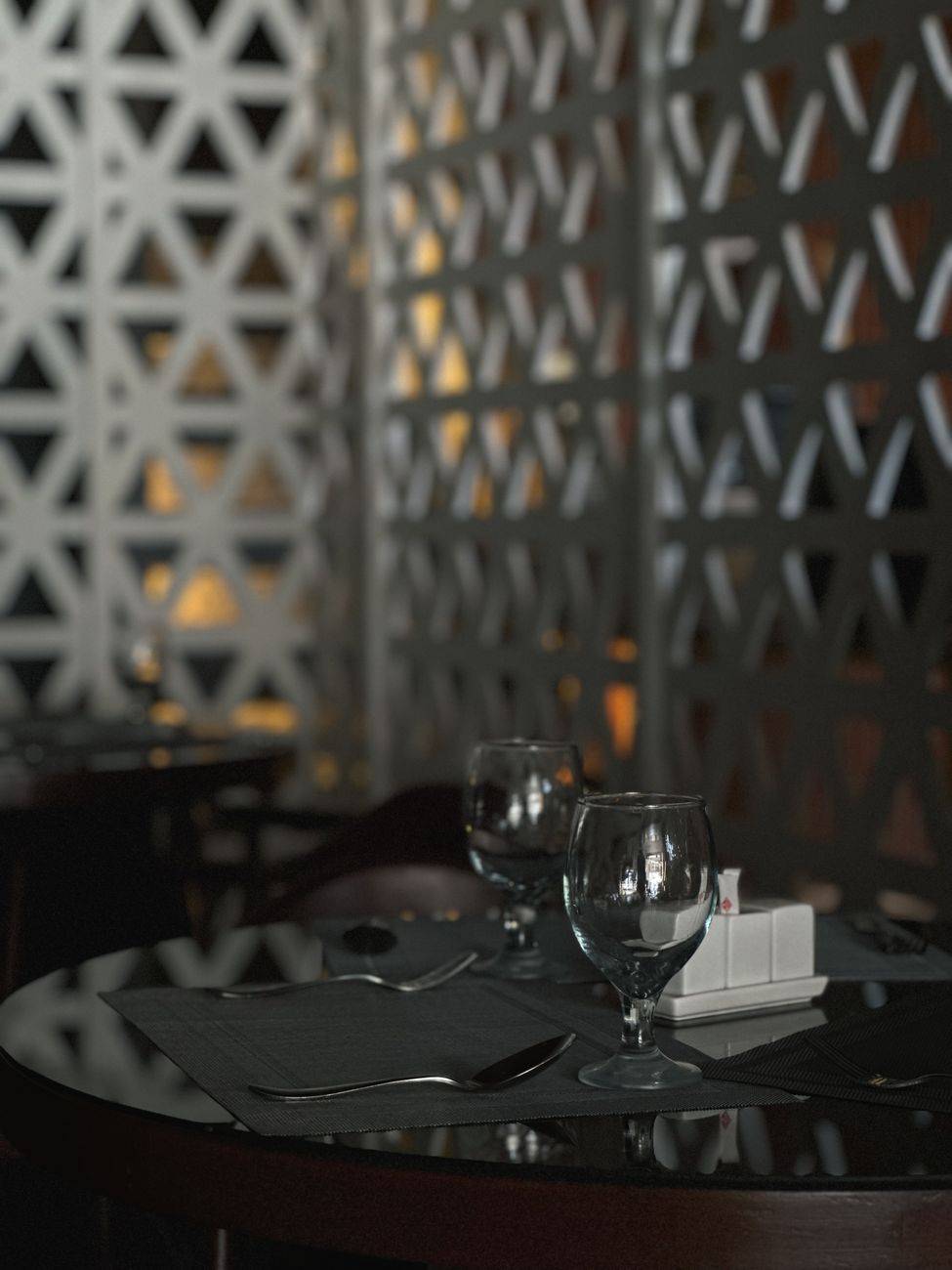 An upscale restaurant table with glassware and silverware arranged elegantly.
