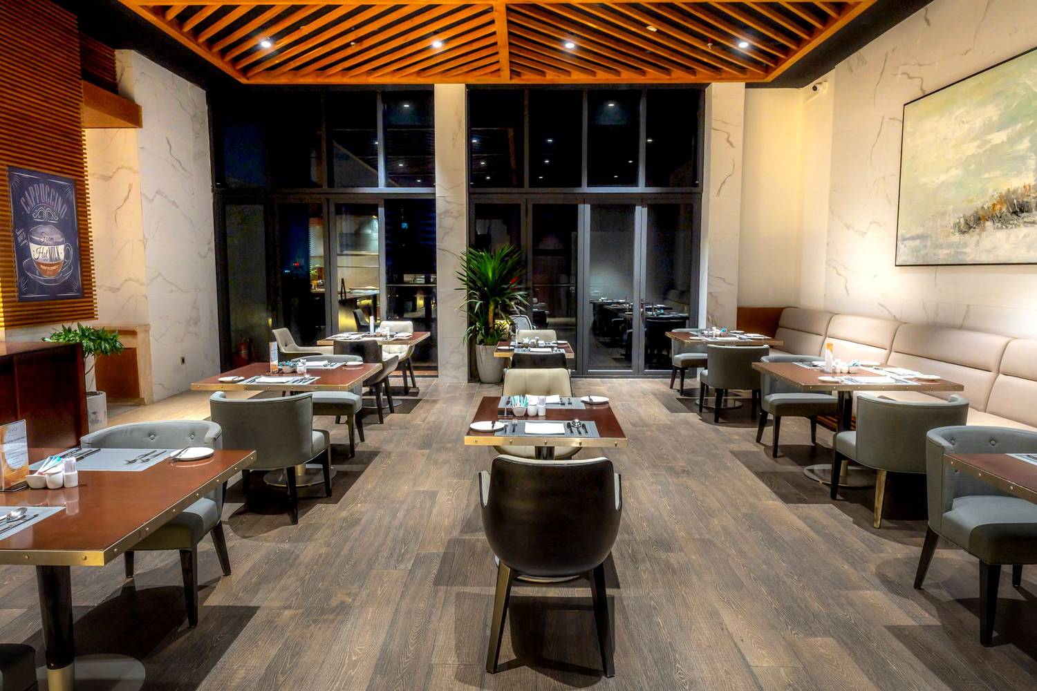 Spacious modern restaurant interior with stylish decor and elegant seating arrangement.