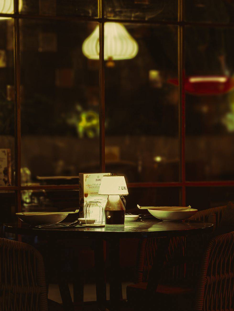 A warm and inviting dinner table setting in a dimly lit restaurant setting.