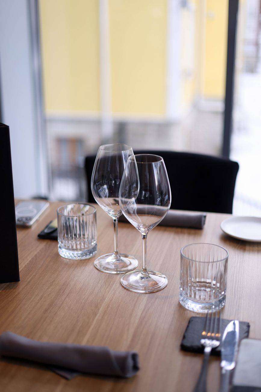 Sophisticated table setting with wine glasses and cutlery ready for a fine dining experience.