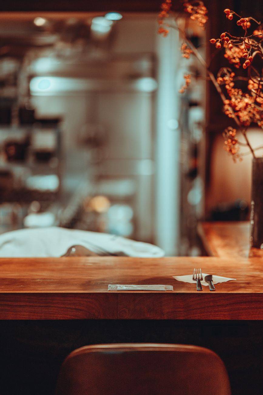 Cozy restaurant interior with elegant table setting and floral decorations, perfect for dining inspiration.