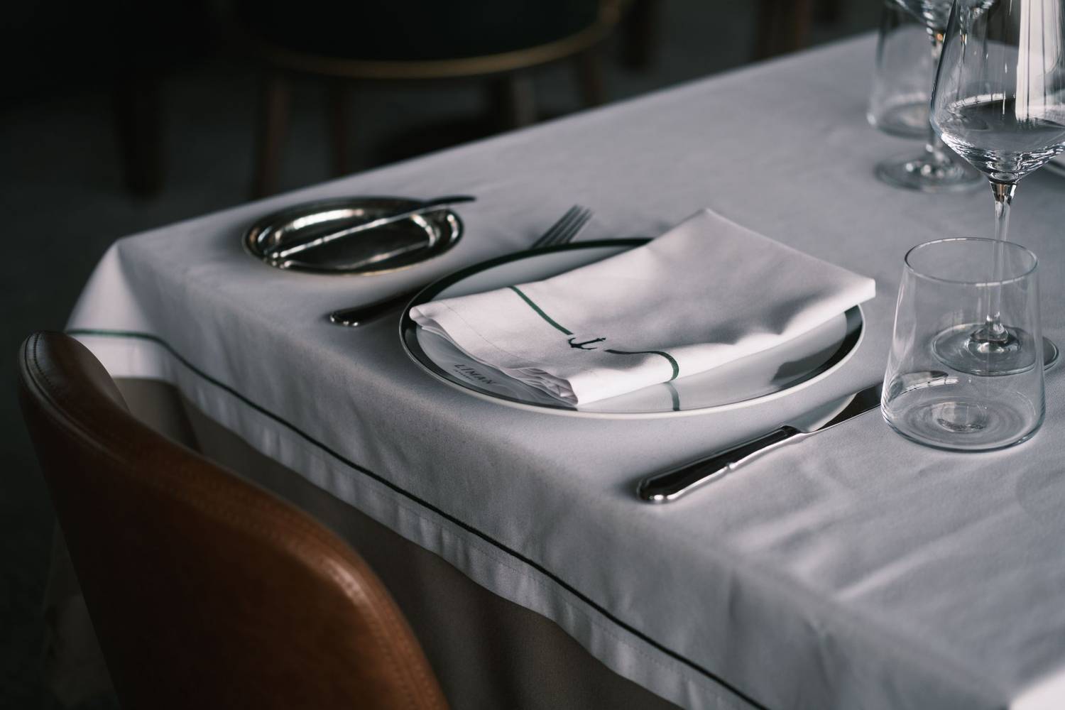 Stylish table setting in a restaurant with glassware and cutlery.