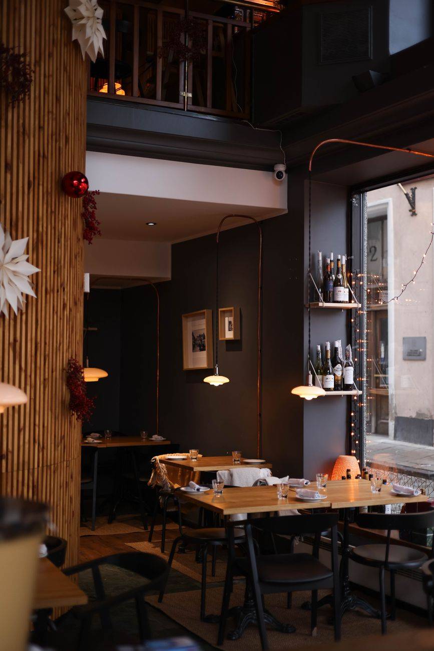 Warm and inviting restaurant interior with elegant lighting and festive decor, perfect for dining.