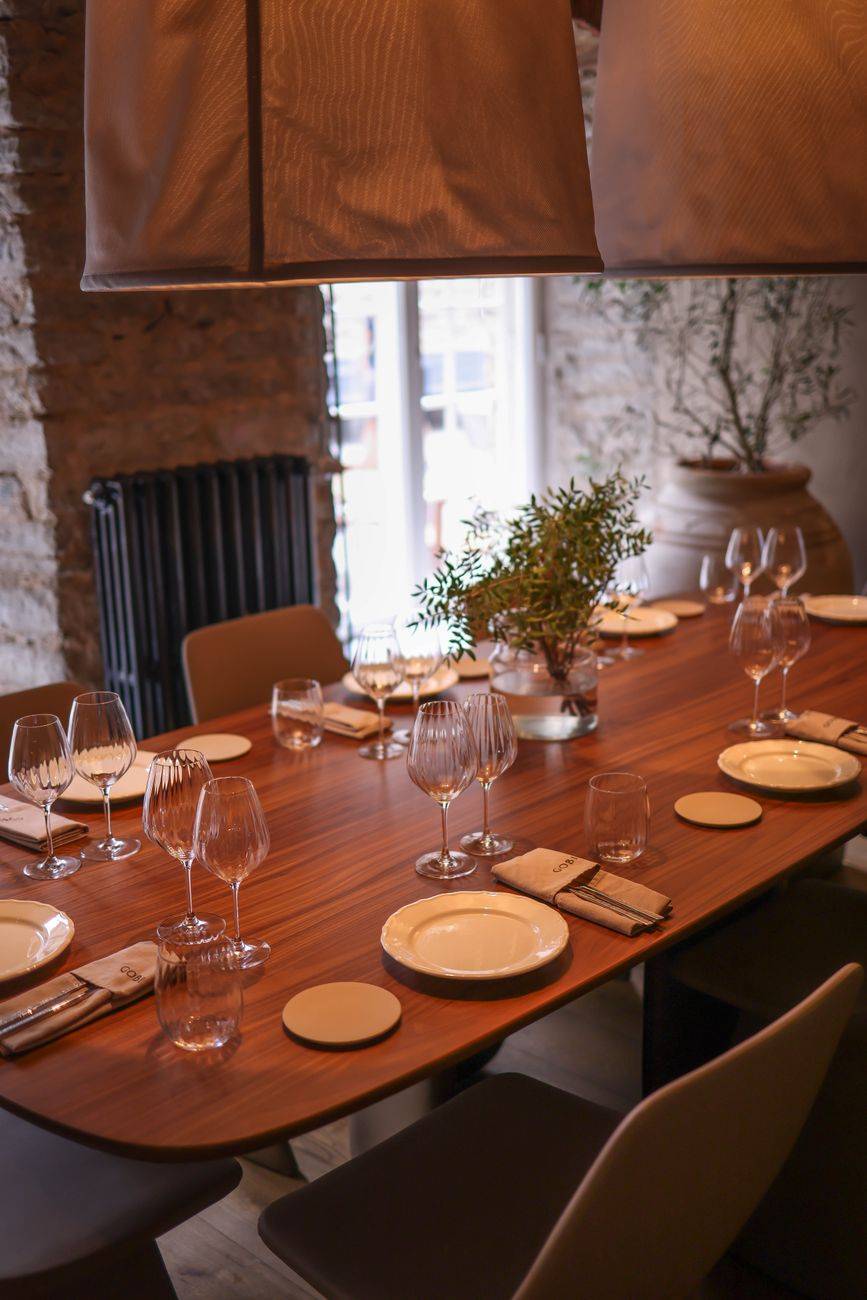 A beautifully set dining table in a luxurious modern restaurant with stylish interior decor.