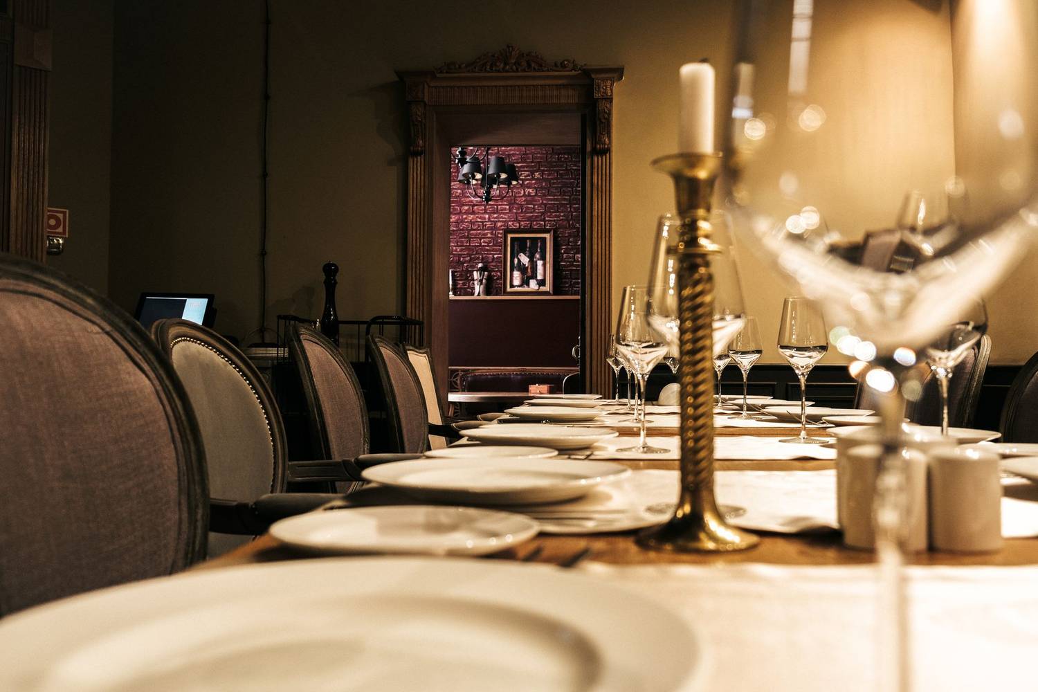 A sophisticated dining setup with candles and wine glasses, ready for an intimate restaurant experience.