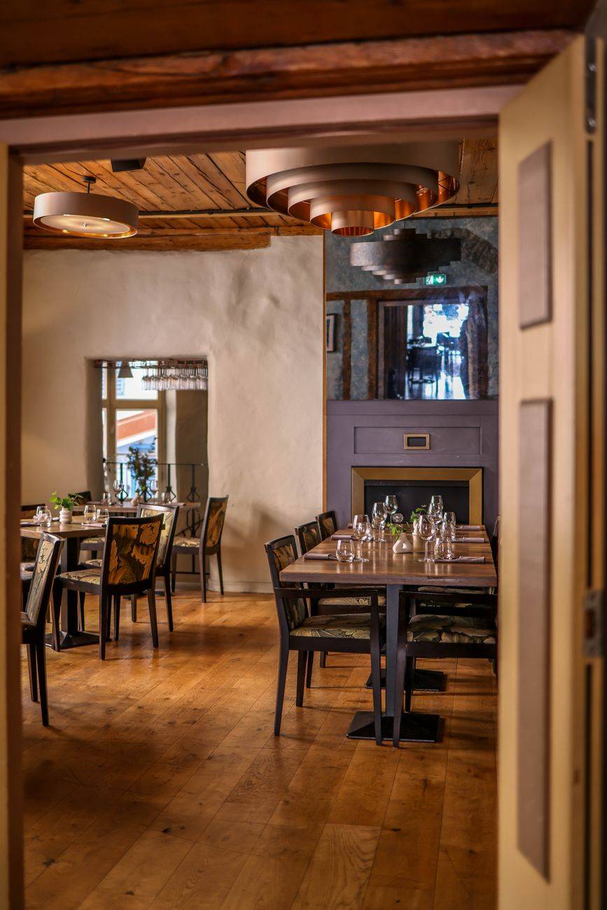 Beautifully decorated dining room with wooden flooring and modern furnishings for a luxurious experience.