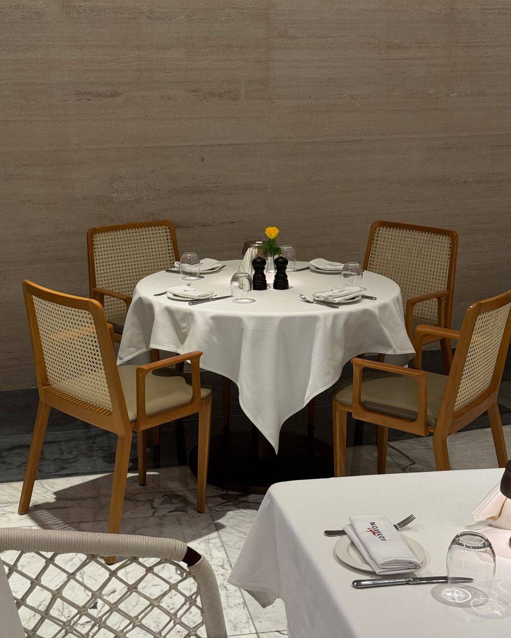 Sophisticated empty dining table with chairs in an upscale restaurant. Perfect for interior dining concepts.
