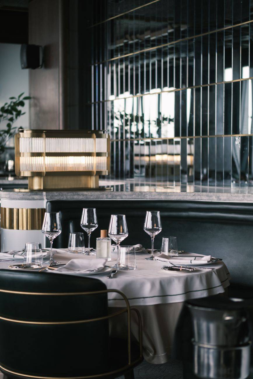 Chic table setup in a modern restaurant with elegant glassware and décor.