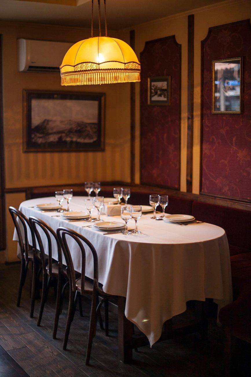 Elegant dining setup in a cozy restaurant with warm lighting and classic decor.