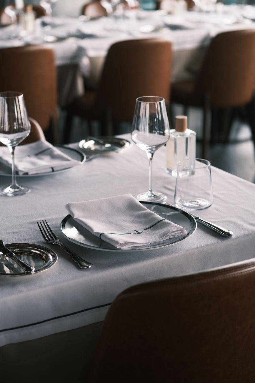 Sophisticated table arrangement in a fine dining restaurant with elegant glassware and cutlery.