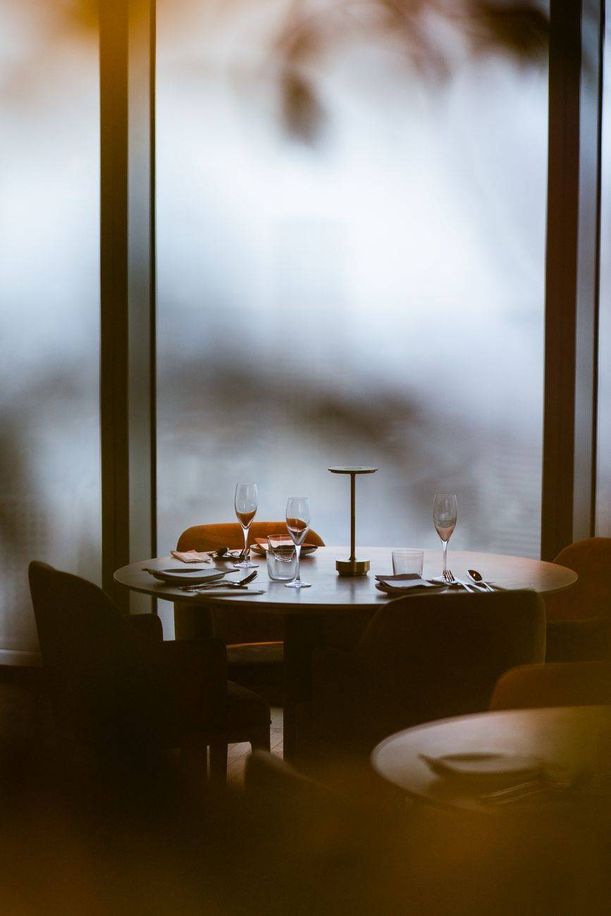 Elegant table setting with glassware in a modern Tokyo restaurant.