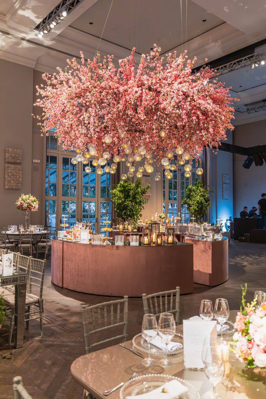 Stunning wedding reception featuring cherry blossom decor and elegant table settings.
