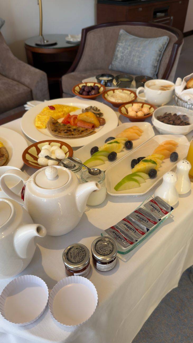 Deluxe hotel breakfast with diverse fruits, pastries, and tea. Perfect start to a luxury day.