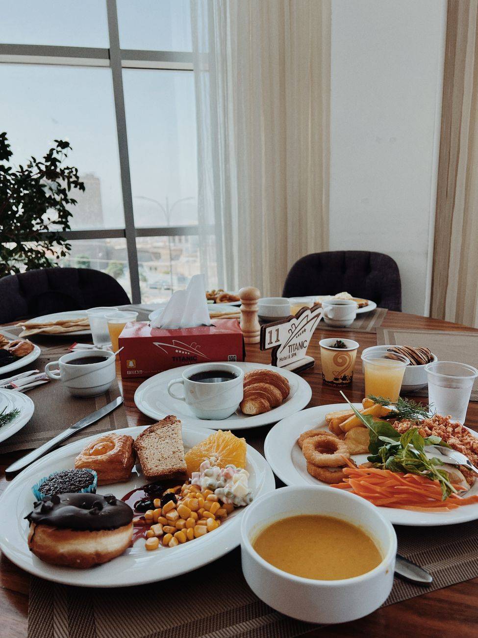 A sumptuous breakfast spread featuring various dishes in a stylish indoor dining setting.