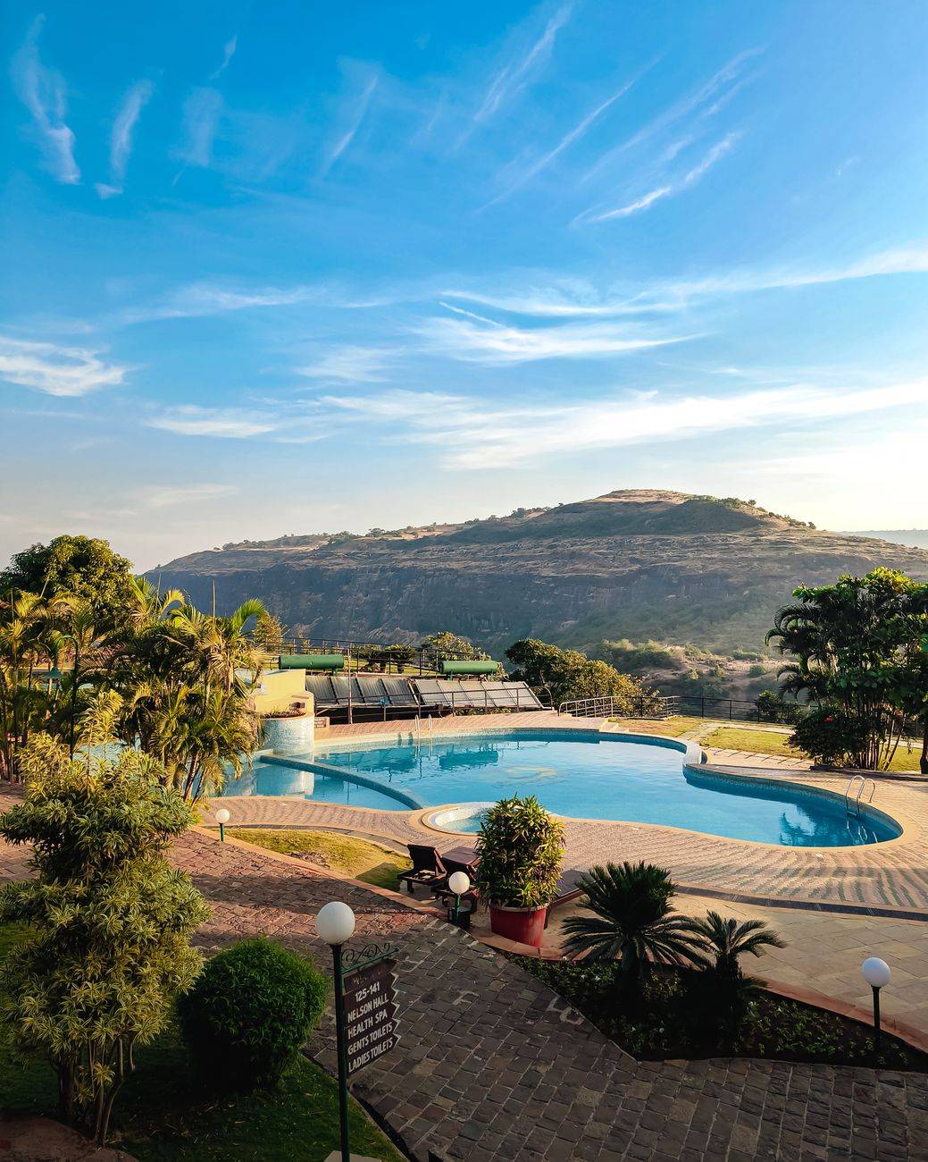 A tranquil resort with a swimming pool nestled in Lonavala's lush hills.