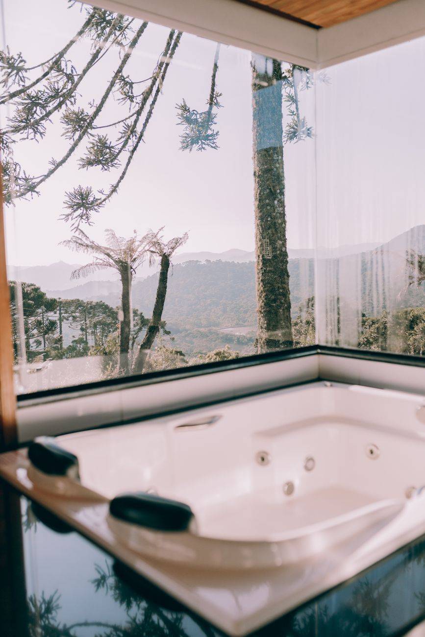 Experience relaxation in a modern bathtub with a stunning mountain view.