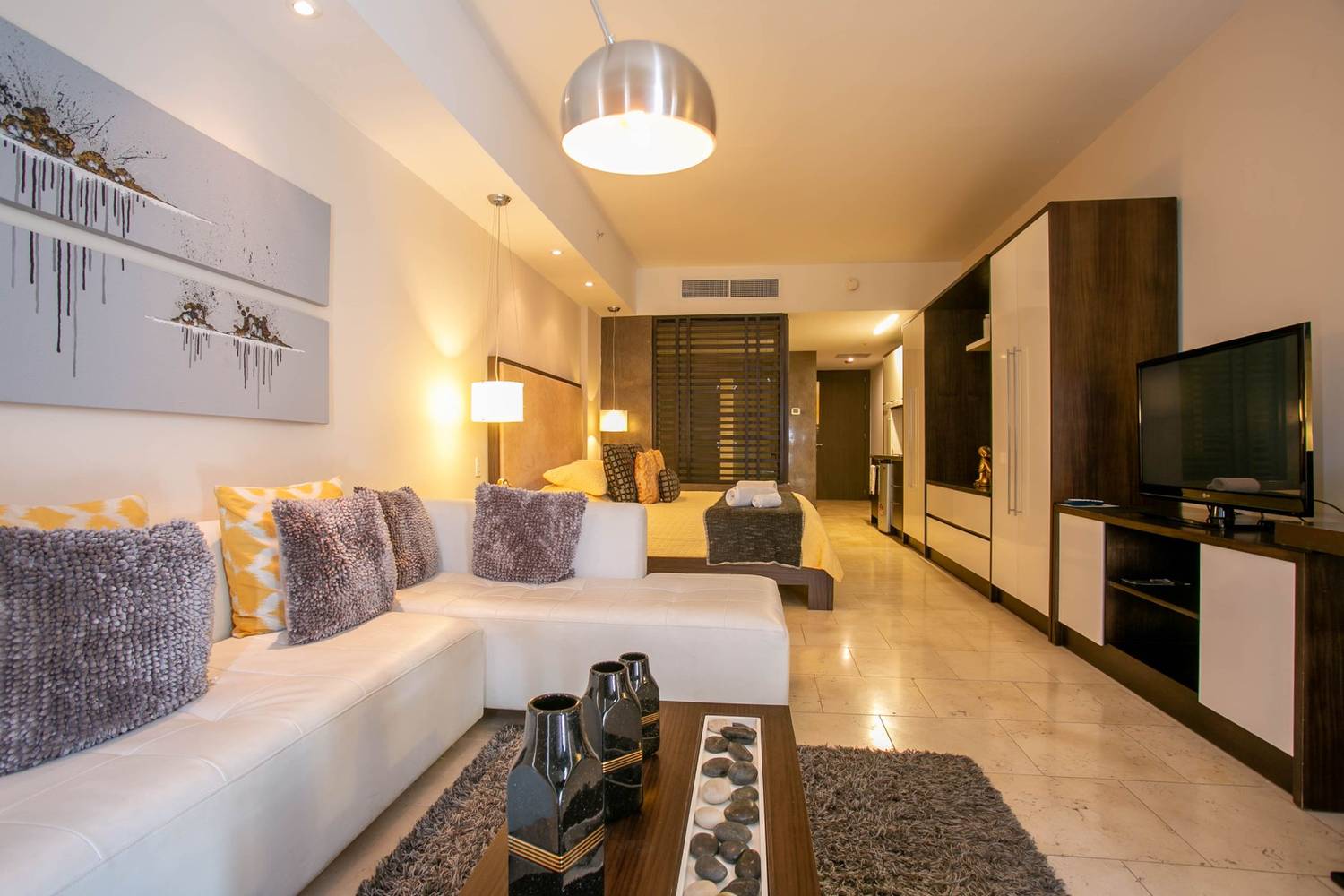 Spacious hotel room with contemporary decor and cozy furnishings.