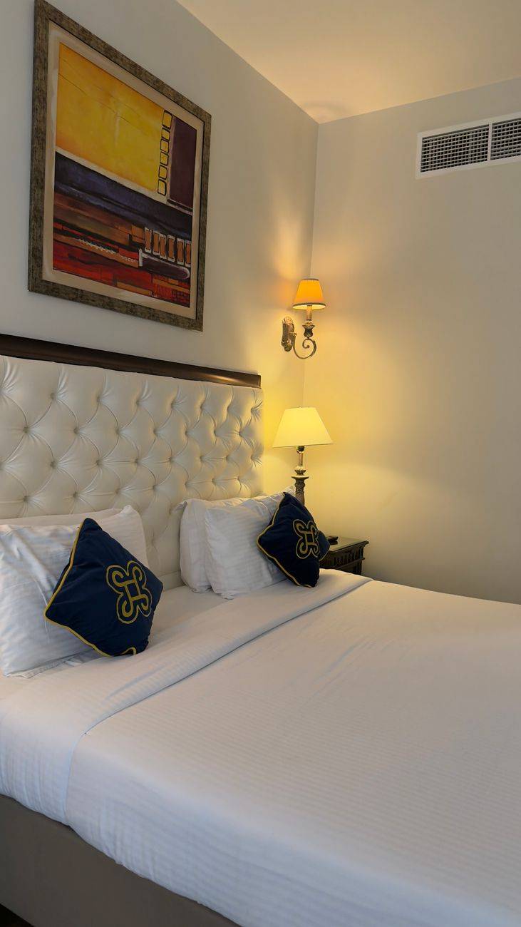 Stylish hotel room showcasing elegant decor with warm ambient lighting and modern art.