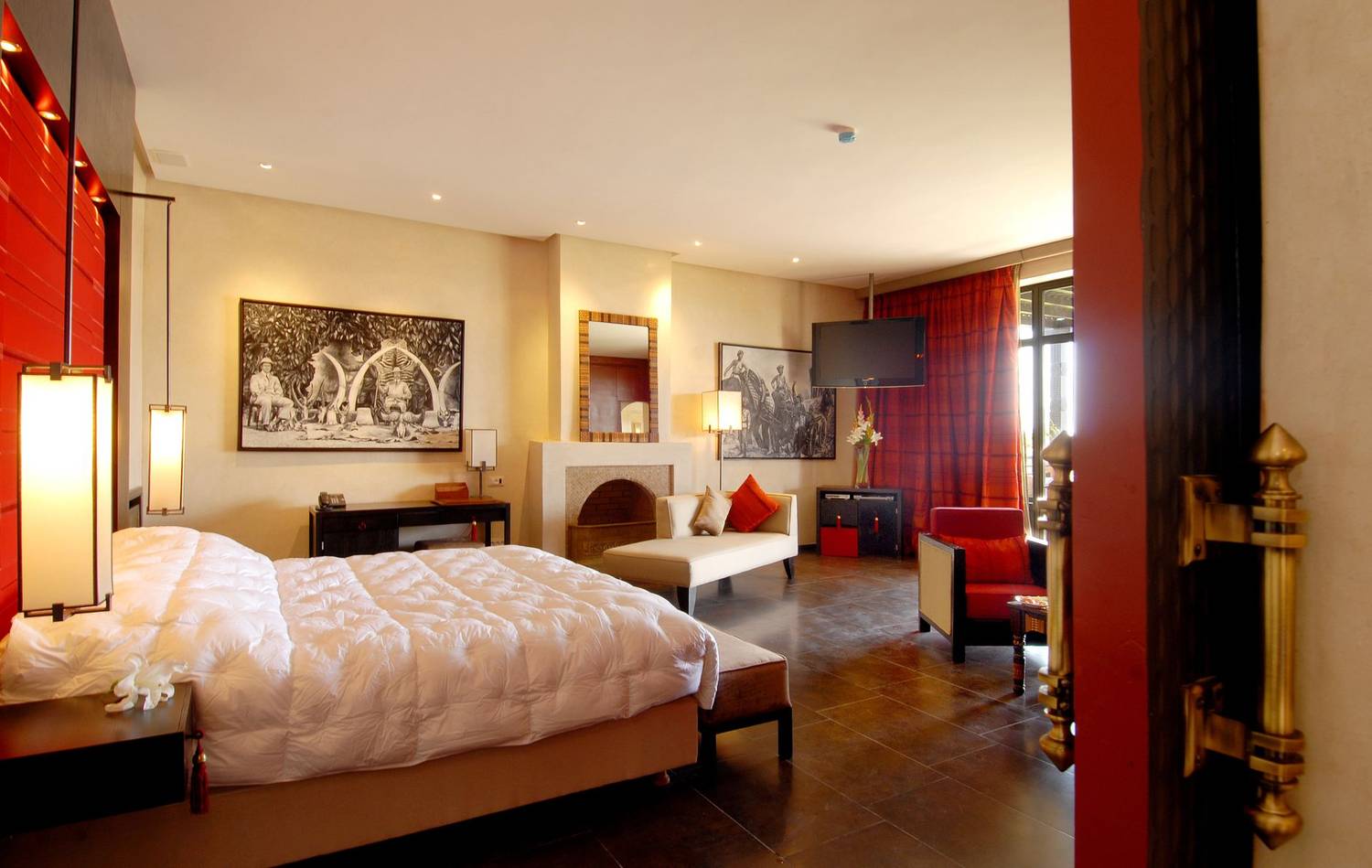 Elegant hotel room featuring modern design, warm lighting, and comfortable furnishings.
