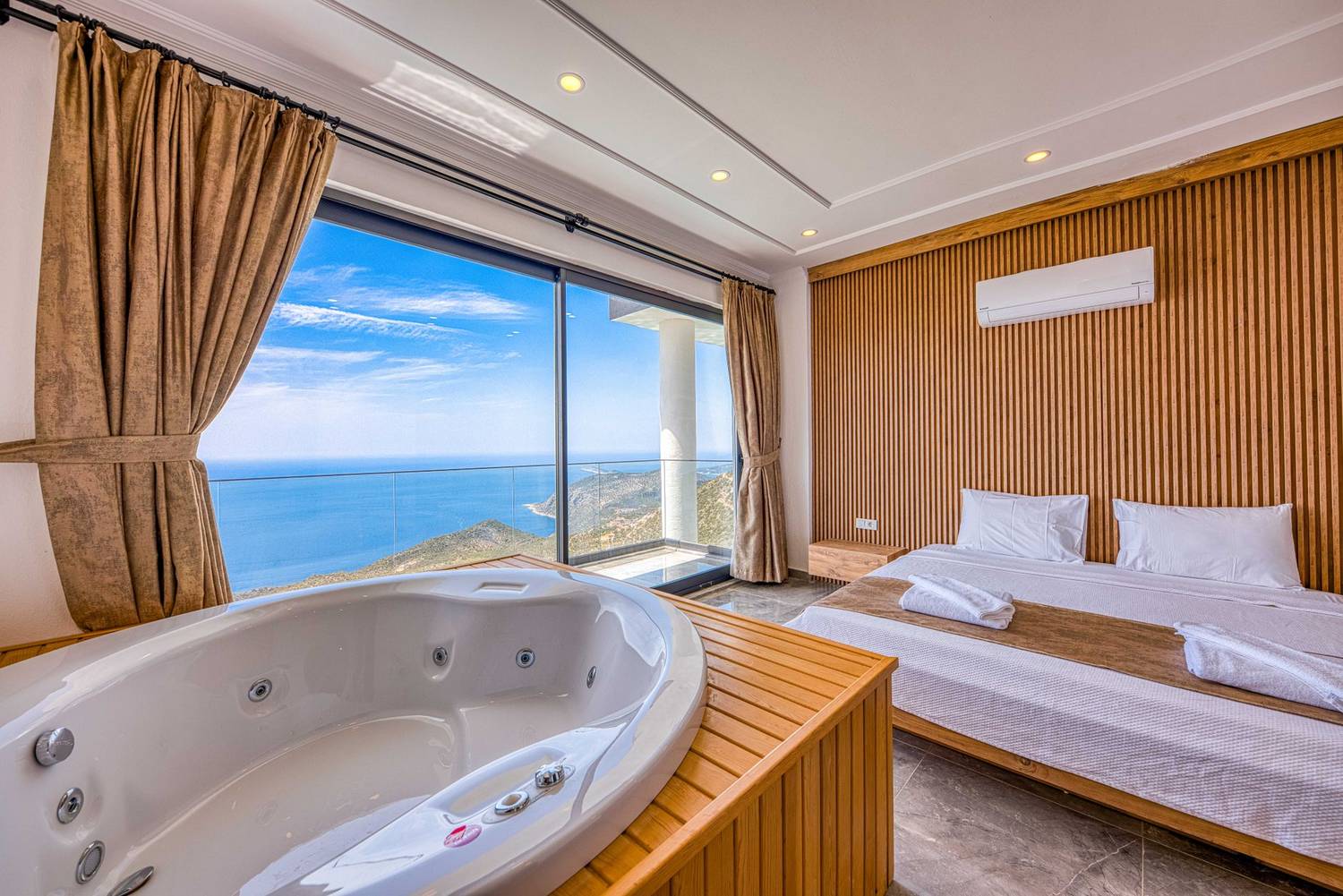 Luxurious hotel room with a stunning ocean view and private jacuzzi.