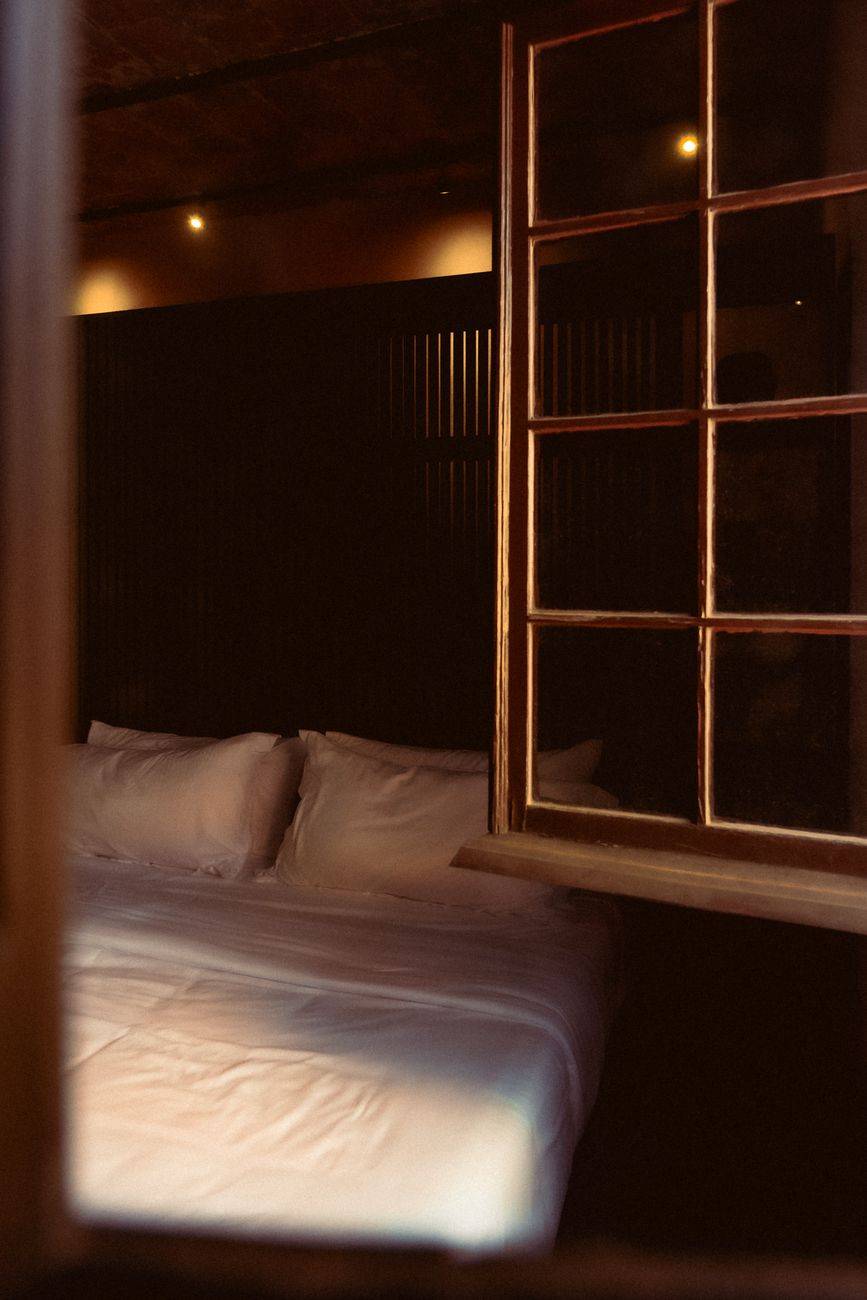 Elegant hotel room in San Luis Potosi, Mexico featuring a cozy bed and warm lighting.