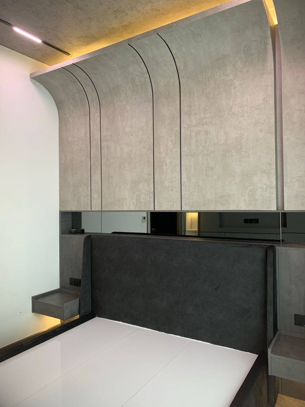 Contemporary minimalist bedroom with sleek furniture and elegant design elements.