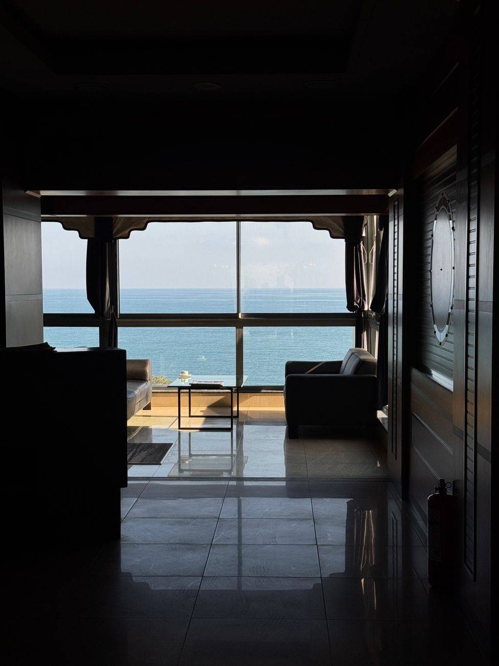 Luxurious hotel room featuring a stunning ocean view from a modern, stylish interior.