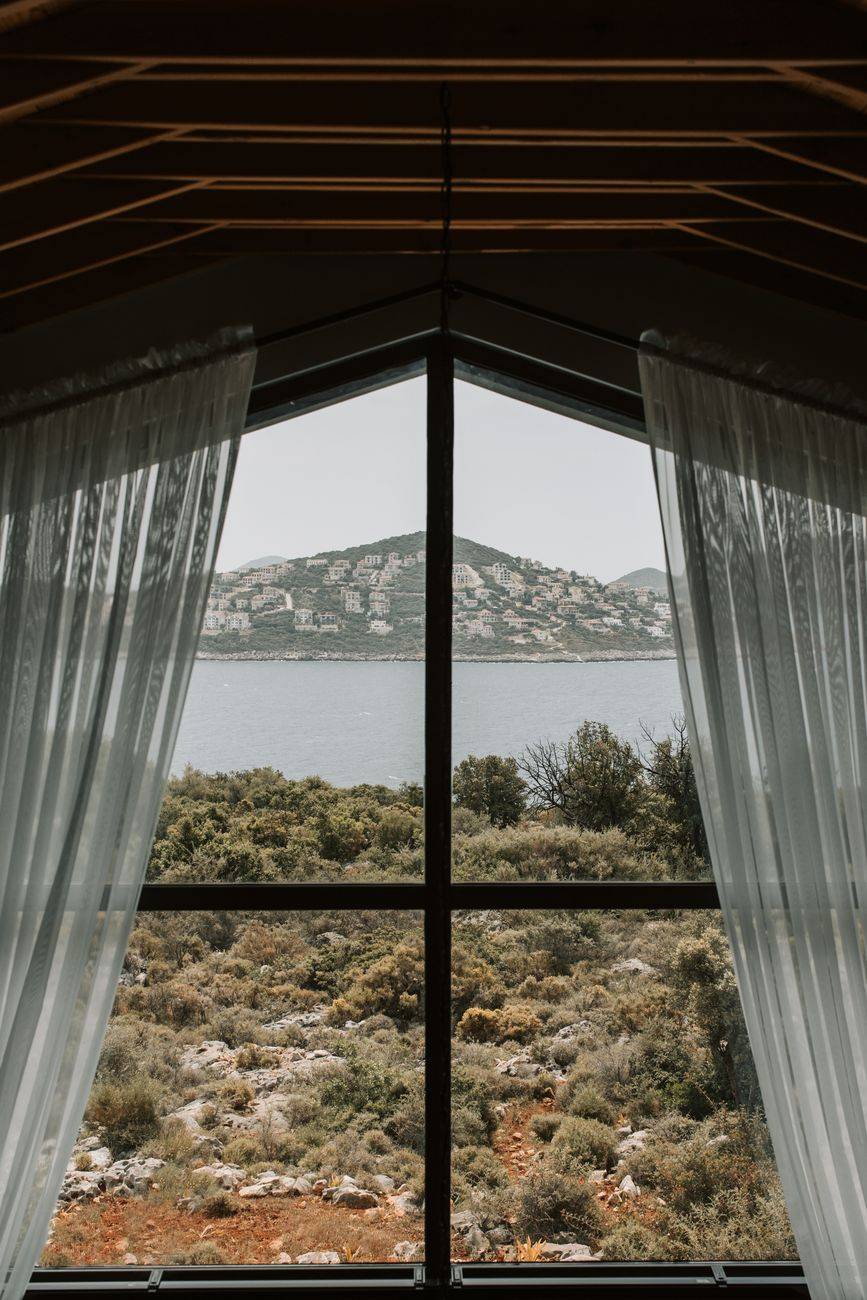 Scenic coastal view through a modern window with minimalistic design, perfect for relaxation.