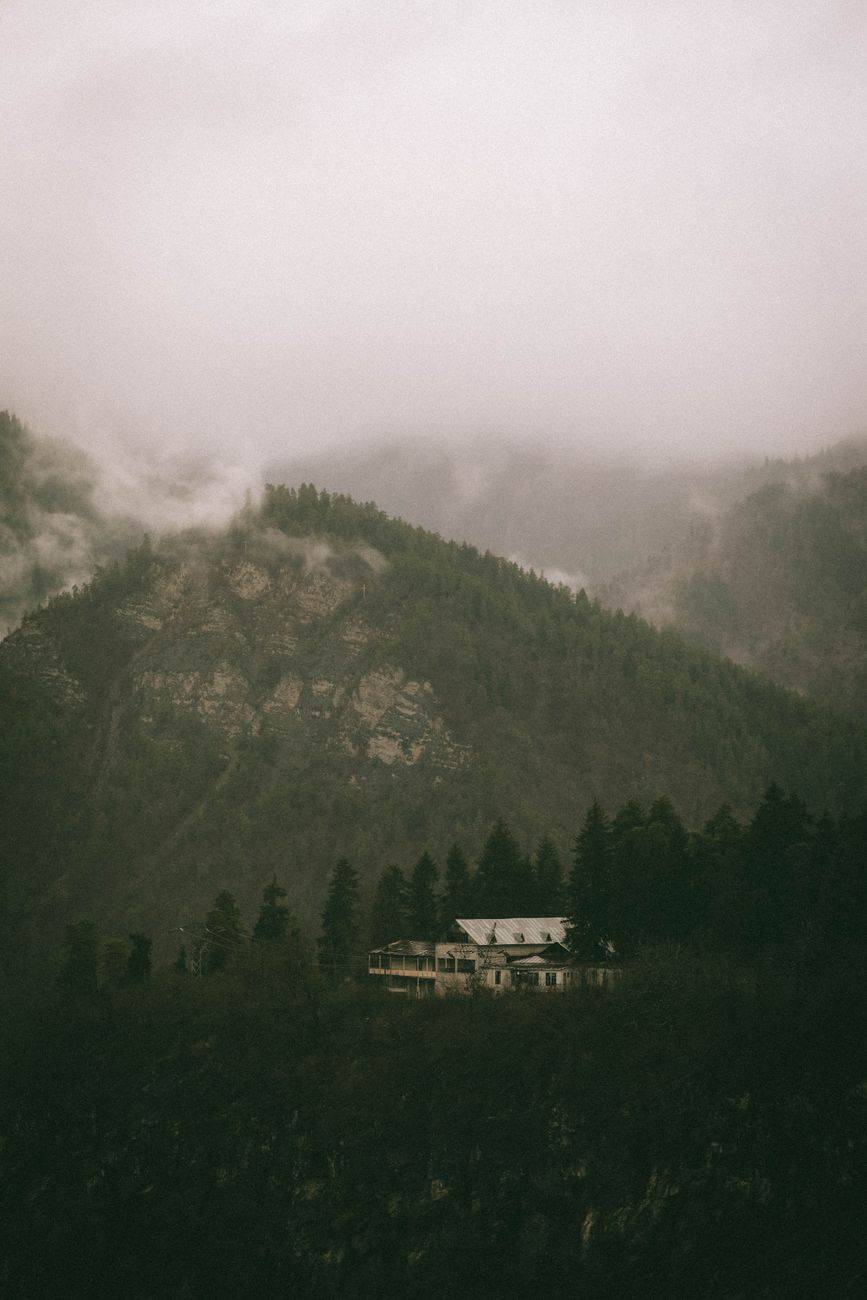 A secluded mountain resort nestled among foggy forests in Georgia's scenic terrain.