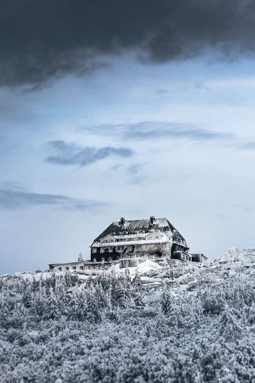 Scenic winter view of a snow-covered house on a hill in Poland.